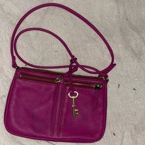 Pre used fossil cross body small purse has a light hue of blue on front of purse